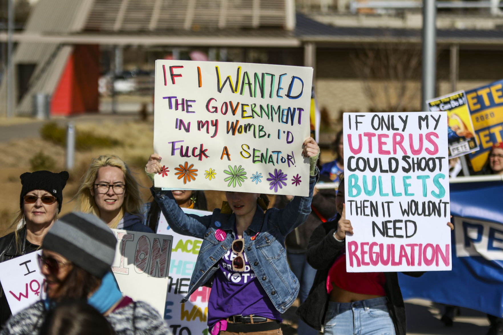 Participants march with signs
